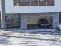 the exterior and landscape of a modern house in los angeles, california with stone and wood