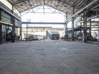 a view of an old factory area in a warehouse building, which has the doors open and the ceiling wide