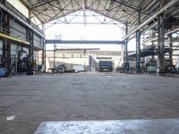 a view of an old factory area in a warehouse building, which has the doors open and the ceiling wide