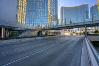 a bus is going down a street next to a high rise building with multiple levels