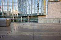 a close - up shot of the outside of an office building with a trash can