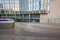 a close - up shot of the outside of an office building with a trash can