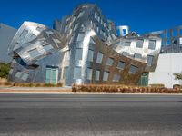 the sculpture is made of aluminum blocks and features metallic squares on the sides and sides of them