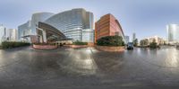 a circular panoramic photograph shows many buildings and cars in a large city area