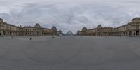 an abstract view of some buildings and a cloudy sky in paris's louvre park