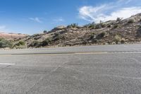 Low Asphalt Road Through Desert Mountains