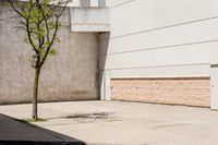 a fire hydrant sitting on the corner of the street next to a building that has boarded doors