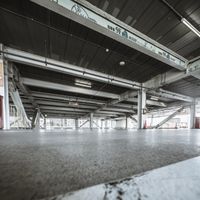 Low Light: A Concrete Floor and Metal Hall