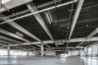 Low Light: A Concrete Floor and Metal Hall