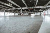 Low Light: A Concrete Floor and Metal Hall