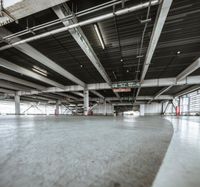 Low Light: A Concrete Floor and Metal Hall