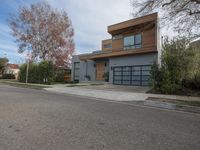 a large modern home is featured as a residential street in this upscale neighborhood with a wooden paneled wall