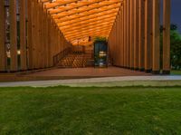 a wooden structure with stairs inside of it in the evening light with dark clouds overhead