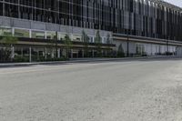 a tall building sitting on the side of a road with lots of windows and no one is wearing shoes