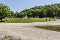 Low Road with Dirt, Asphalt, Grass, and Trees