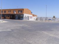 a empty road with an orange building in the background, next to a sign that says, you can see this