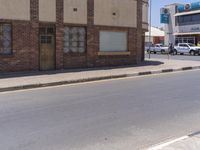 a building with the sign that reads to the right of the road is a closed street, with a yellow line on the road in front of it, and some buildings