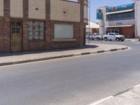 a building with the sign that reads to the right of the road is a closed street, with a yellow line on the road in front of it, and some buildings