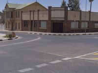 a building with the sign that reads to the right of the road is a closed street, with a yellow line on the road in front of it, and some buildings