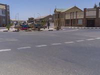 a building with the sign that reads to the right of the road is a closed street, with a yellow line on the road in front of it, and some buildings