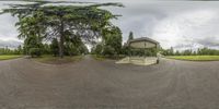 a fisheye image of the park with its beautiful gazebo on a cloudy day