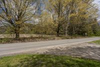 a road passing by with no cars or people on it and trees in the background