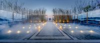 there is a hot pool with candles lit up near the water and the mountains in the background