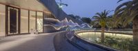 the fountain is surrounded by large water sculptures at the hotel entrance of the hotel with a beautiful reflection of it's exterior