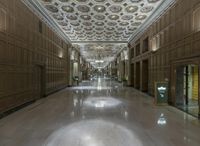 a large hall with wood paneled ceilings and stone floors and ceilings decorated with ornaments