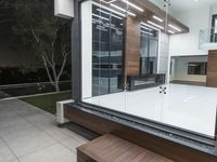 the home has a pool that is outside at night, as well as modern furniture