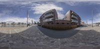 a fish eye picture of the front yard and courtyard of a luxury apartment building, which appears to be under construction