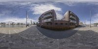 a fish eye picture of the front yard and courtyard of a luxury apartment building, which appears to be under construction