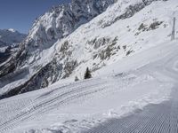 a man skiing down a slope on a mountain side at a ski resort on the slopes