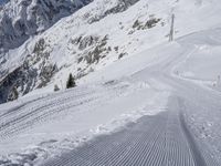 a man skiing down a slope on a mountain side at a ski resort on the slopes