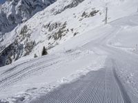 a man skiing down a slope on a mountain side at a ski resort on the slopes