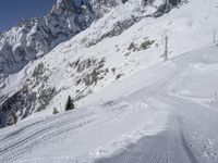 a man skiing down a slope on a mountain side at a ski resort on the slopes