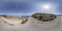 a big fisheye lens captures a winding road on the coast line of the aegean