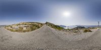 the view from above of a mountain in the sun, with a skateboard flying off top