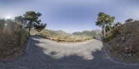 a small photo from a 360 - turn camera of the mountain road in the middle of nowhere