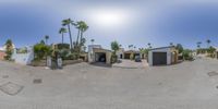 an exterior 360 - view of a building with several garages and palm trees on it