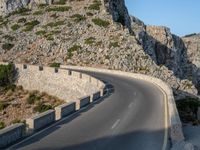 an empty highway winds off into the mountainside in california's cabo mountains