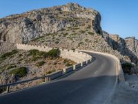 an empty highway winds off into the mountainside in california's cabo mountains