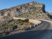 an empty highway winds off into the mountainside in california's cabo mountains