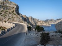 an empty highway winds off into the mountainside in california's cabo mountains