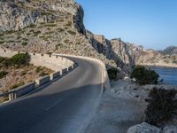 an empty highway winds off into the mountainside in california's cabo mountains