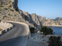 an empty highway winds off into the mountainside in california's cabo mountains