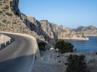 an empty highway winds off into the mountainside in california's cabo mountains