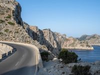 an empty highway winds off into the mountainside in california's cabo mountains