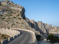 an empty highway winds off into the mountainside in california's cabo mountains