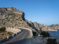 an empty highway winds off into the mountainside in california's cabo mountains
